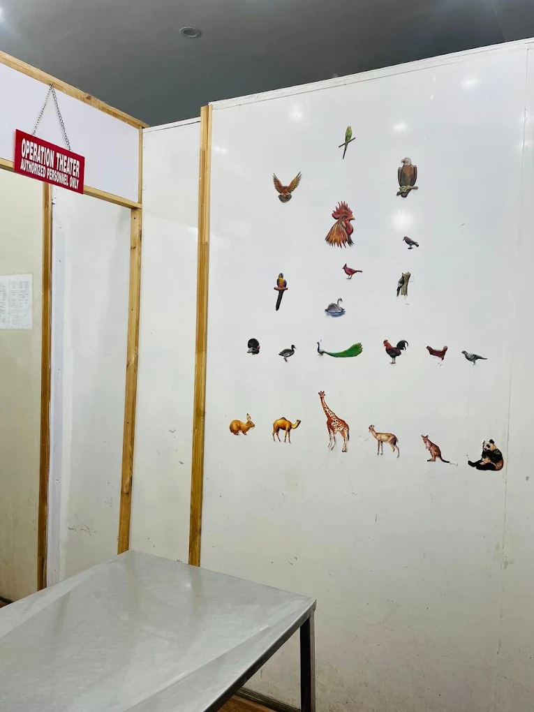 The clinic operation theatre with a steel surgical table and an authorised personnel sign